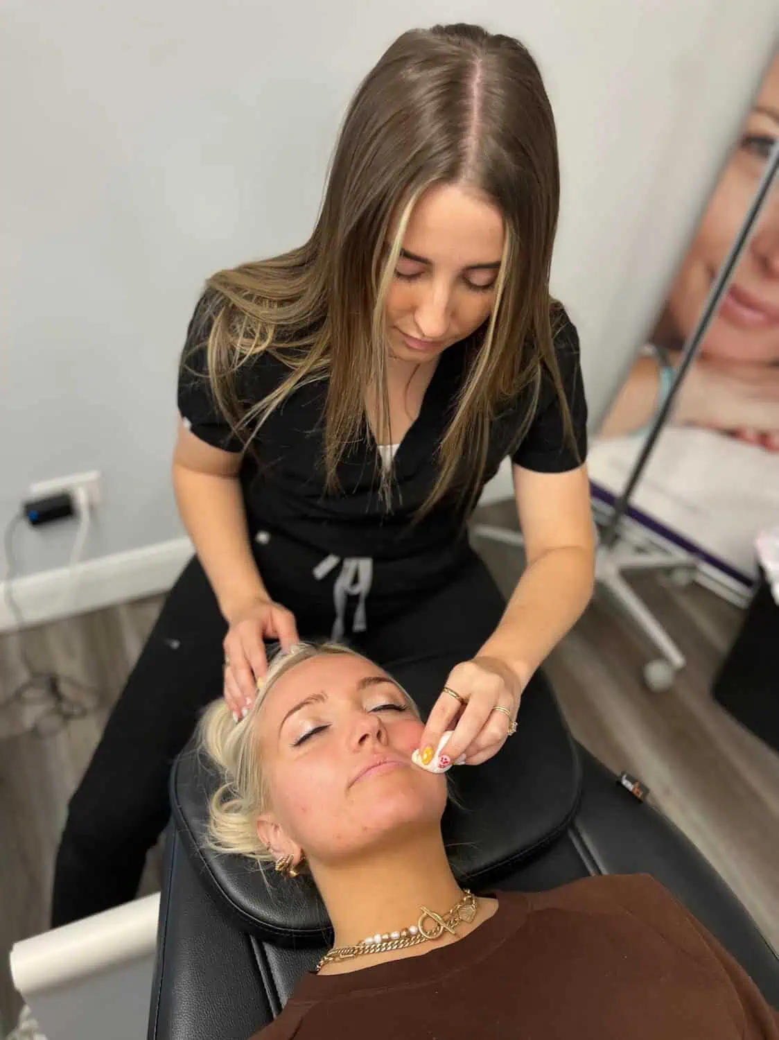 A provider treating a patient's face at Optimal Health in Provo